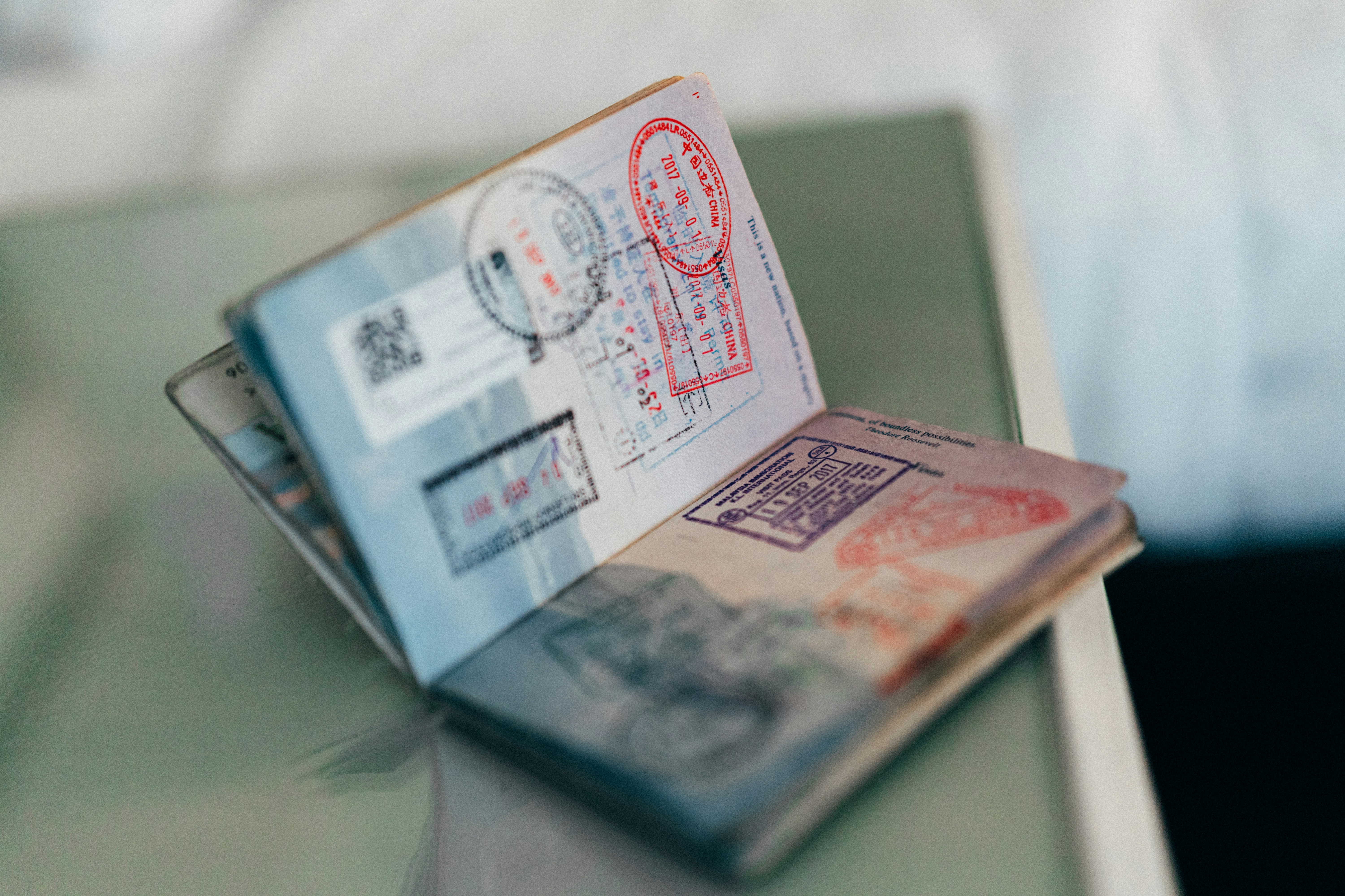 Passport, visa application form and pen arranged on a wooden desk